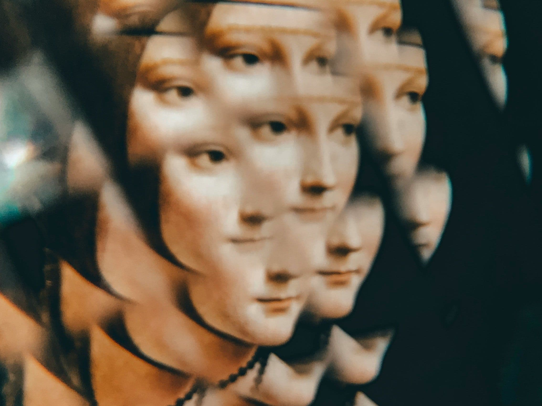 Überlagertes Gesicht einer Schaufensterpuppe, mehrfach gespiegelt und unscharf vervielfacht.